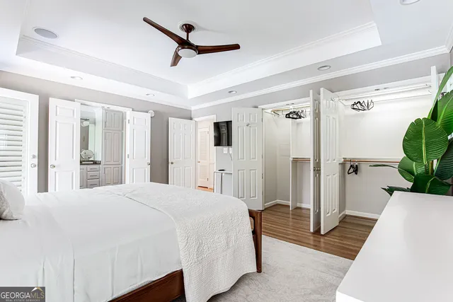 a spacious bedroom with a bed and a large mirror