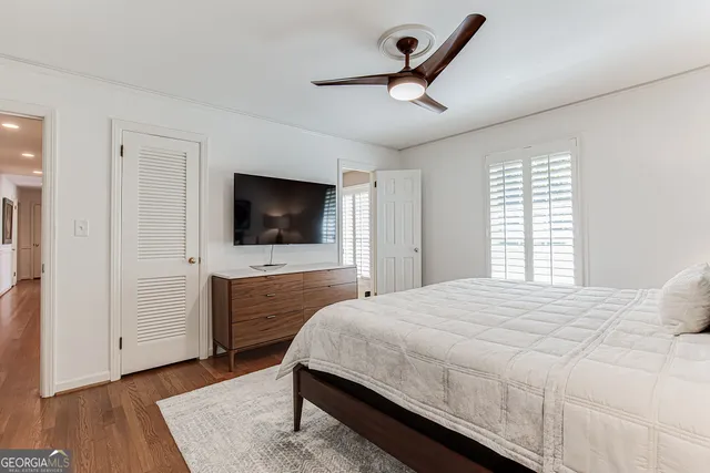 a bathroom with a granite countertop sink a toilet and shower