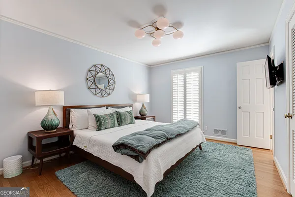 a bedroom with a bed and a flat screen tv