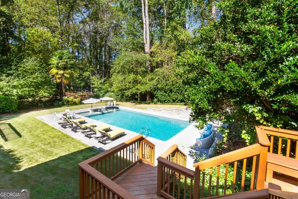 a balcony with wooden floor and yard