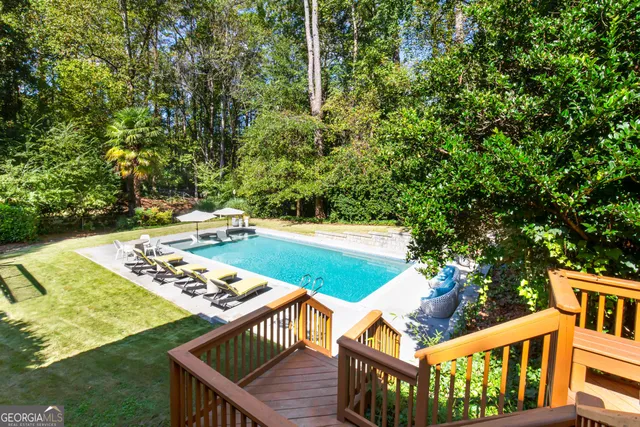 a balcony with wooden floor and yard