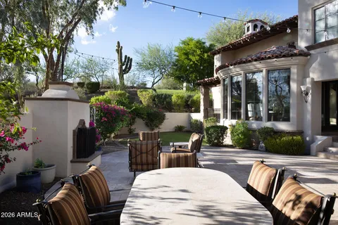 a kitchen with stainless steel appliances granite countertop a sink a stove and a wooden cabinets