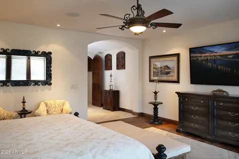 a living room with furniture a chandelier and a floor to ceiling window