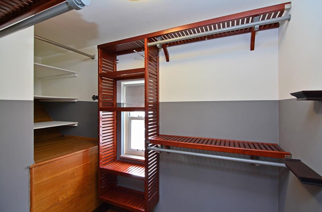 130 Harding Road Pittsburgh, PA 15229 - Photo 13 of 23 The custom walk-in closet showcases wood shelving and abundant space for hanging clothes.