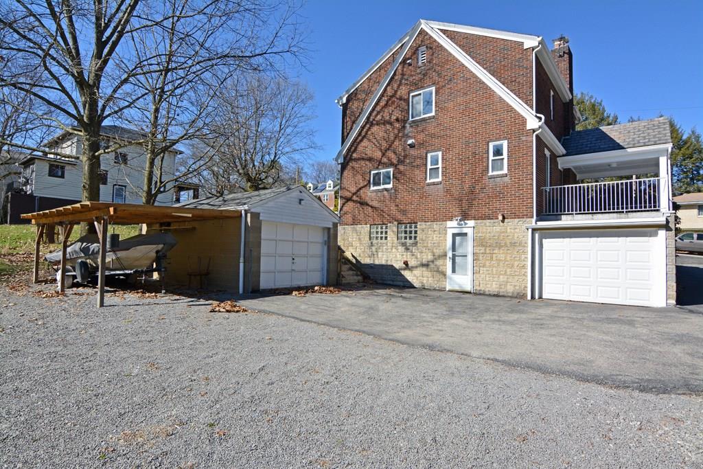130 Harding Road Pittsburgh, PA 15229 - Photo 19 of 23 The rear of the home offers garage space for two cars, plus a covered vehicle bay and extended driveway space for extra parking.