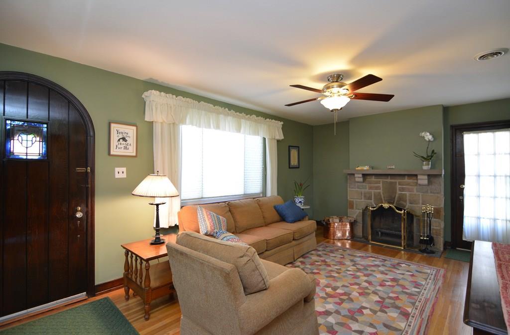 130 Harding Road Pittsburgh, PA 15229 - Photo 5 of 23 Warm and inviting, the living room features a handsome stone fireplace, oak hardwood flooring and walkout to the covered side deck.