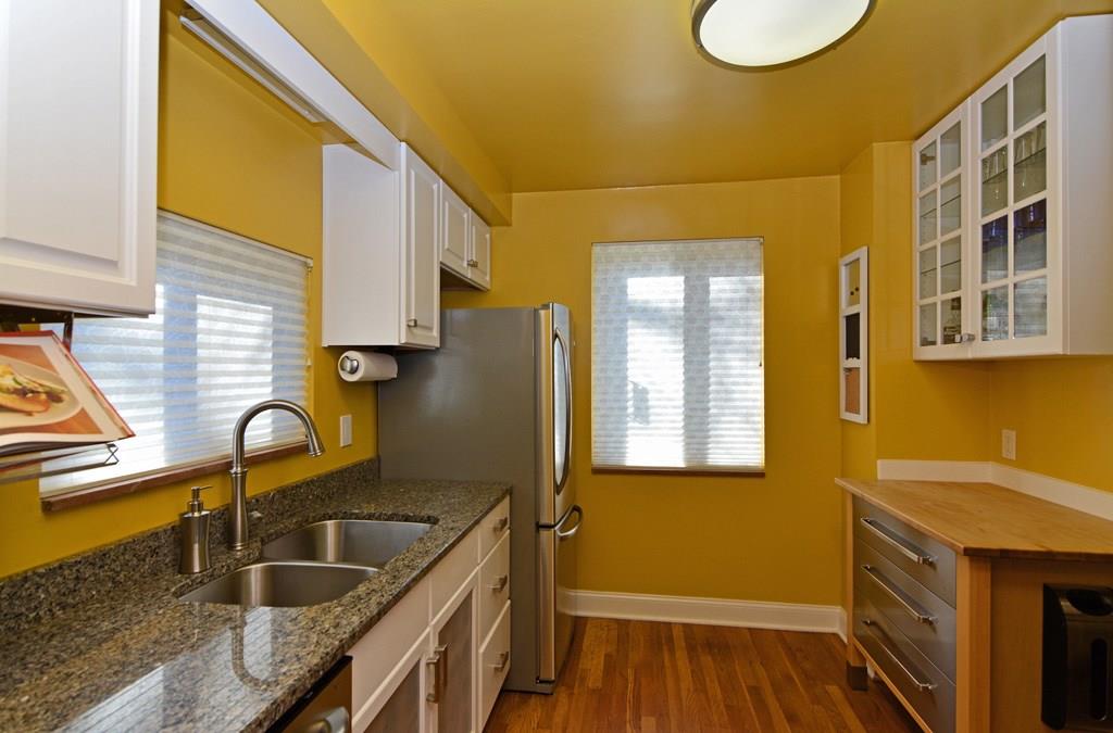 130 Harding Road Pittsburgh, PA 15229 - Photo 9 of 23 Recently updated, the kitchen boasts granite countertops, hardwood flooring, white cabinetry (some with glass fronts) and high-quality stainless steel appliances.