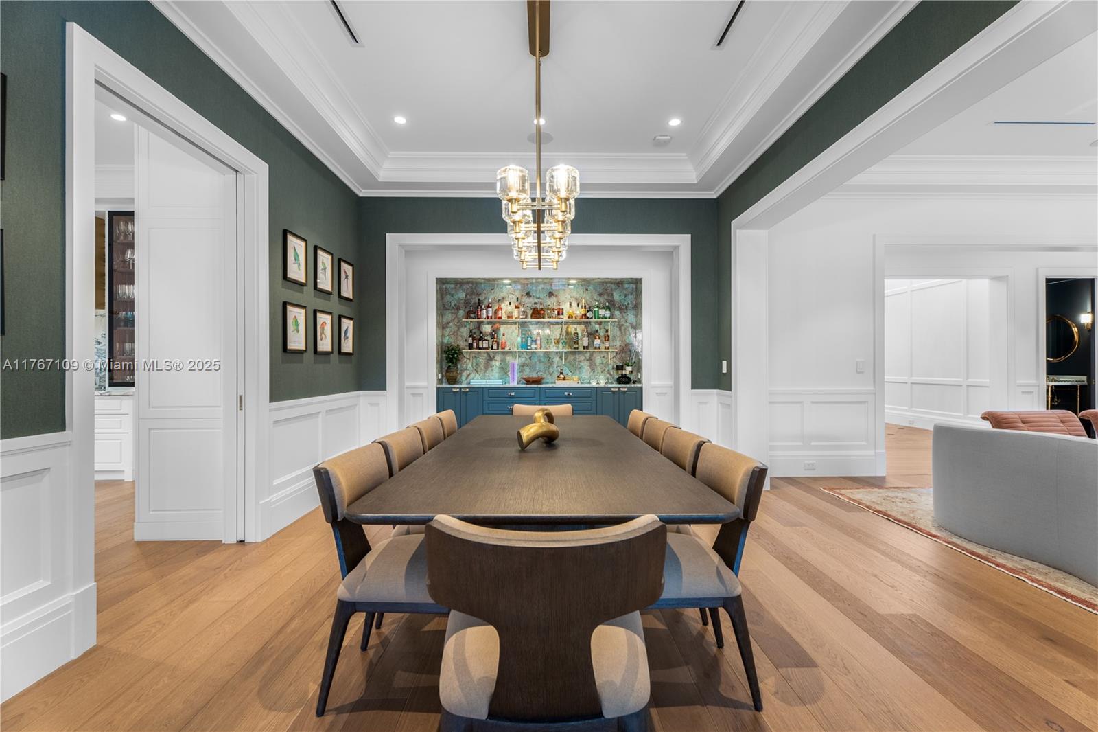 6575 Southwest 96th Street Pinecrest, FL 33156 - Photo 31 of 95 a view of a dining room with furniture wooden floor and chandelier