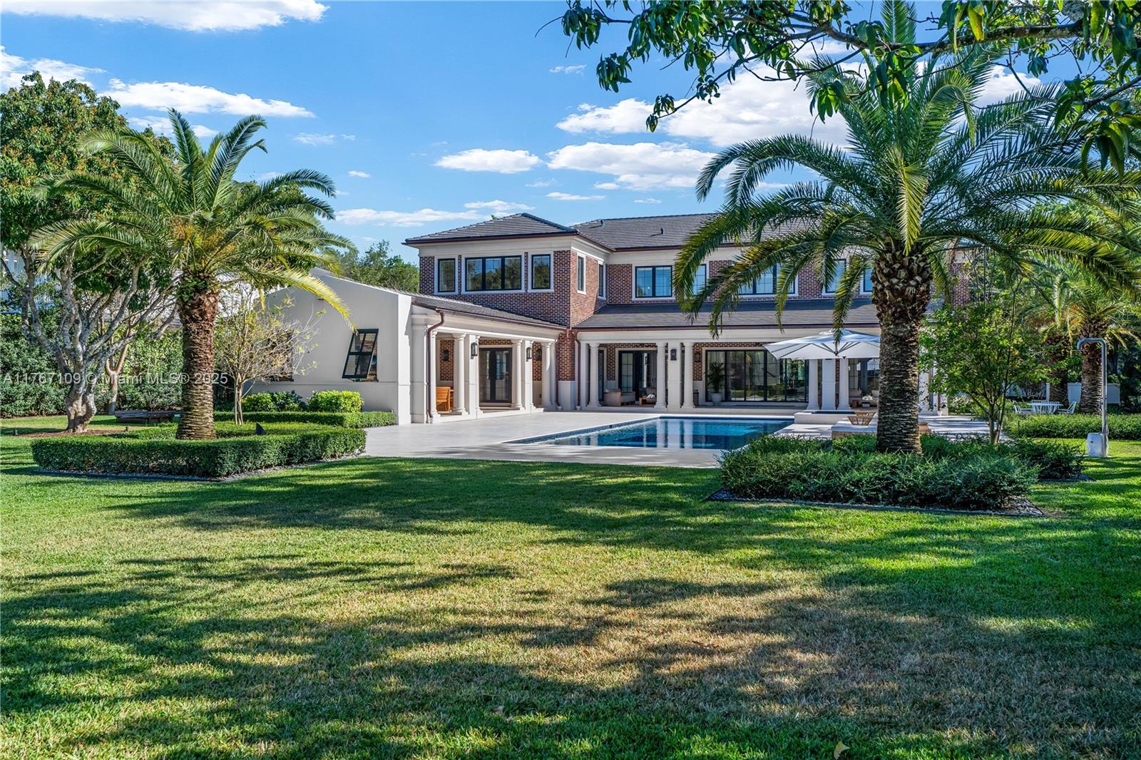 6575 Southwest 96th Street Pinecrest, FL 33156 - Photo 47 of 95 a front view of a house with a garden