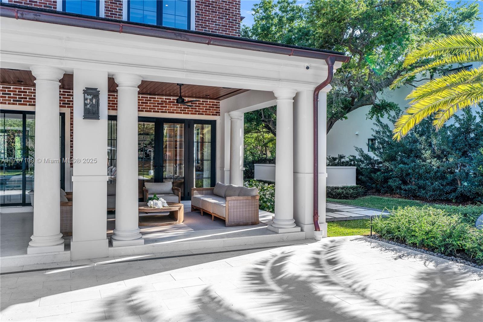 6575 Southwest 96th Street Pinecrest, FL 33156 - Photo 49 of 95 a view of a patio with table and chairs potted plants and floor to ceiling window