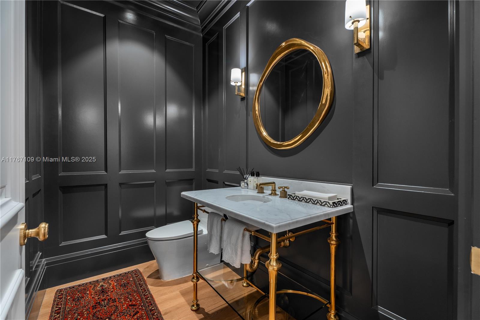 6575 Southwest 96th Street Pinecrest, FL 33156 - Photo 65 of 95 a bathroom with a sink a toilet and mirror