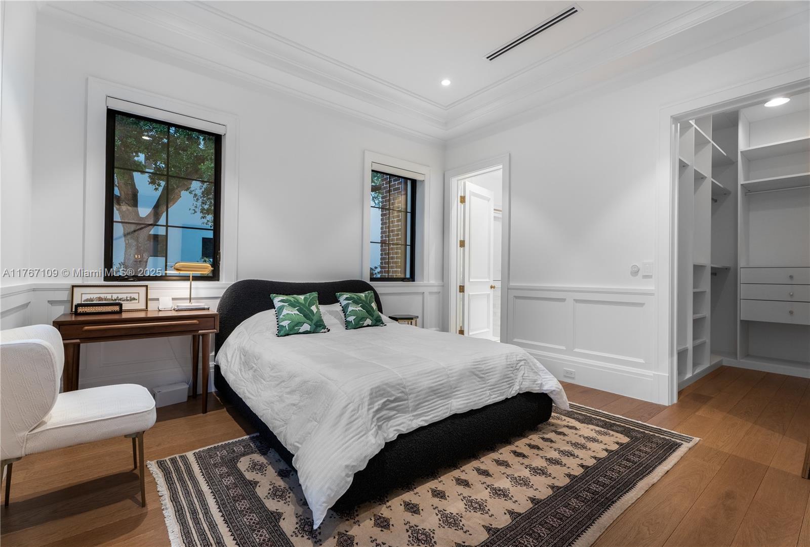6575 Southwest 96th Street Pinecrest, FL 33156 - Photo 66 of 95 a bedroom with a bed and wooden floor