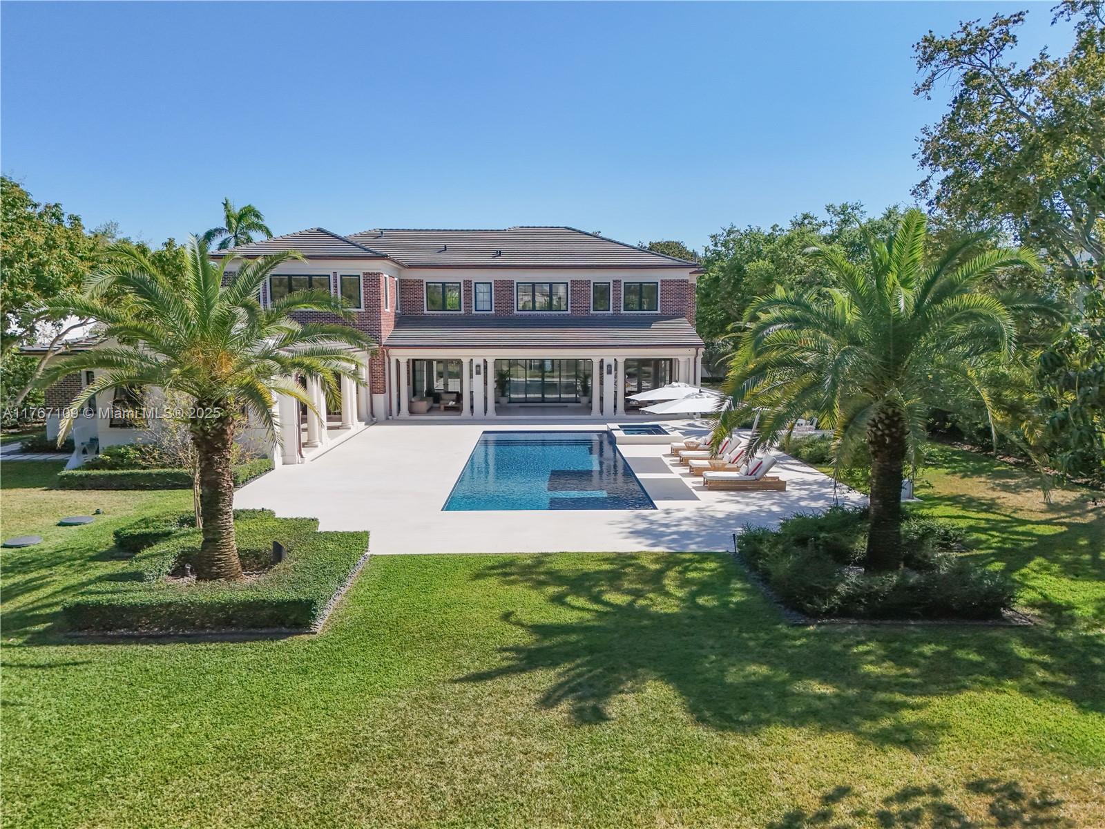 6575 Southwest 96th Street Pinecrest, FL 33156 - Photo 72 of 95 a front view of a house with a yard