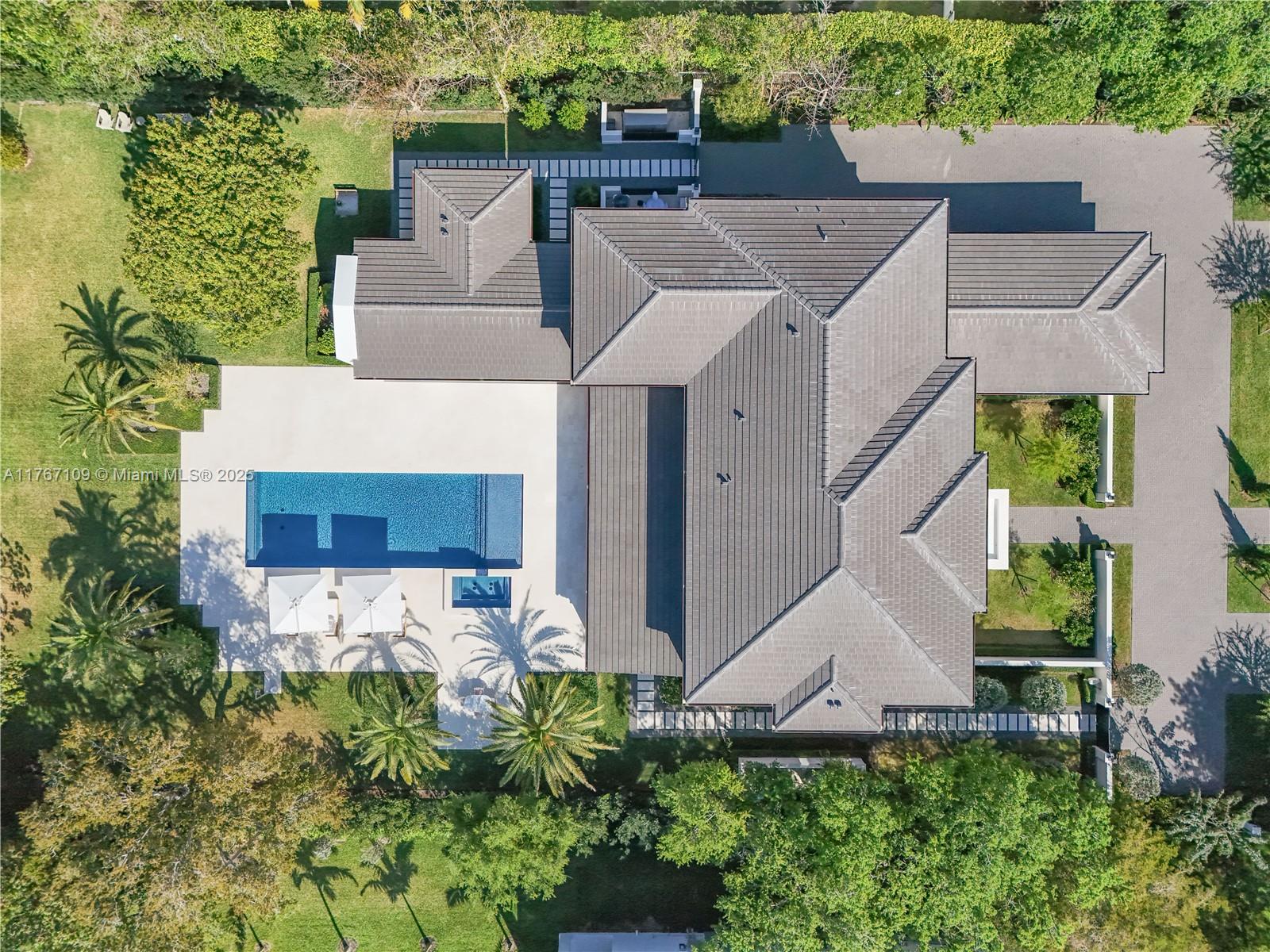 6575 Southwest 96th Street Pinecrest, FL 33156 - Photo 81 of 95 an aerial view of a house with a yard and potted plants