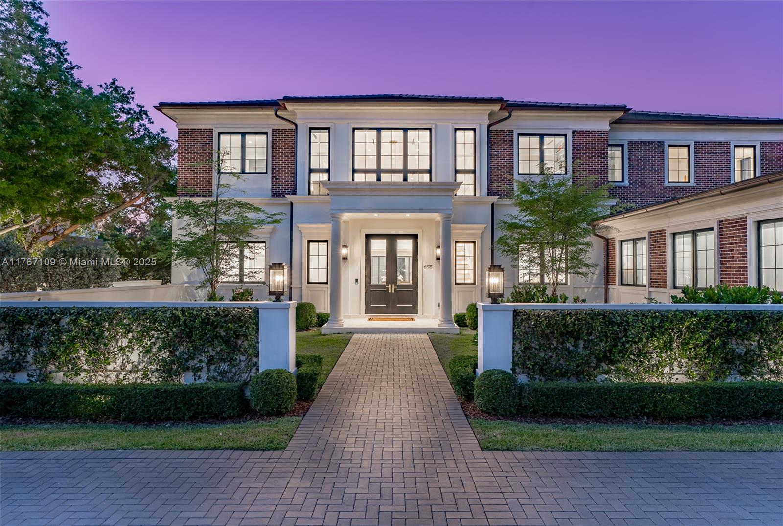 6575 Southwest 96th Street Pinecrest, FL 33156 - Photo 85 of 95 a front view of a house with garden