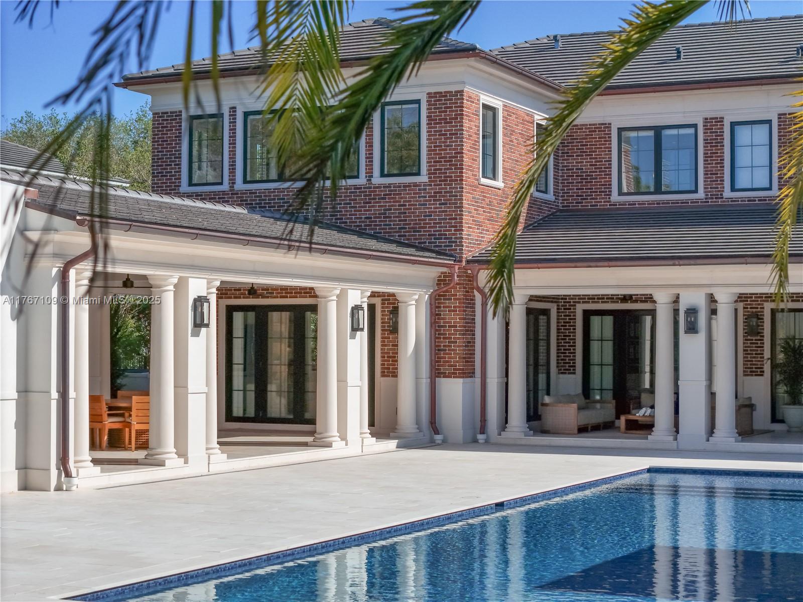 6575 Southwest 96th Street Pinecrest, FL 33156 - Photo 89 of 95 front view of a brick house with a large windows