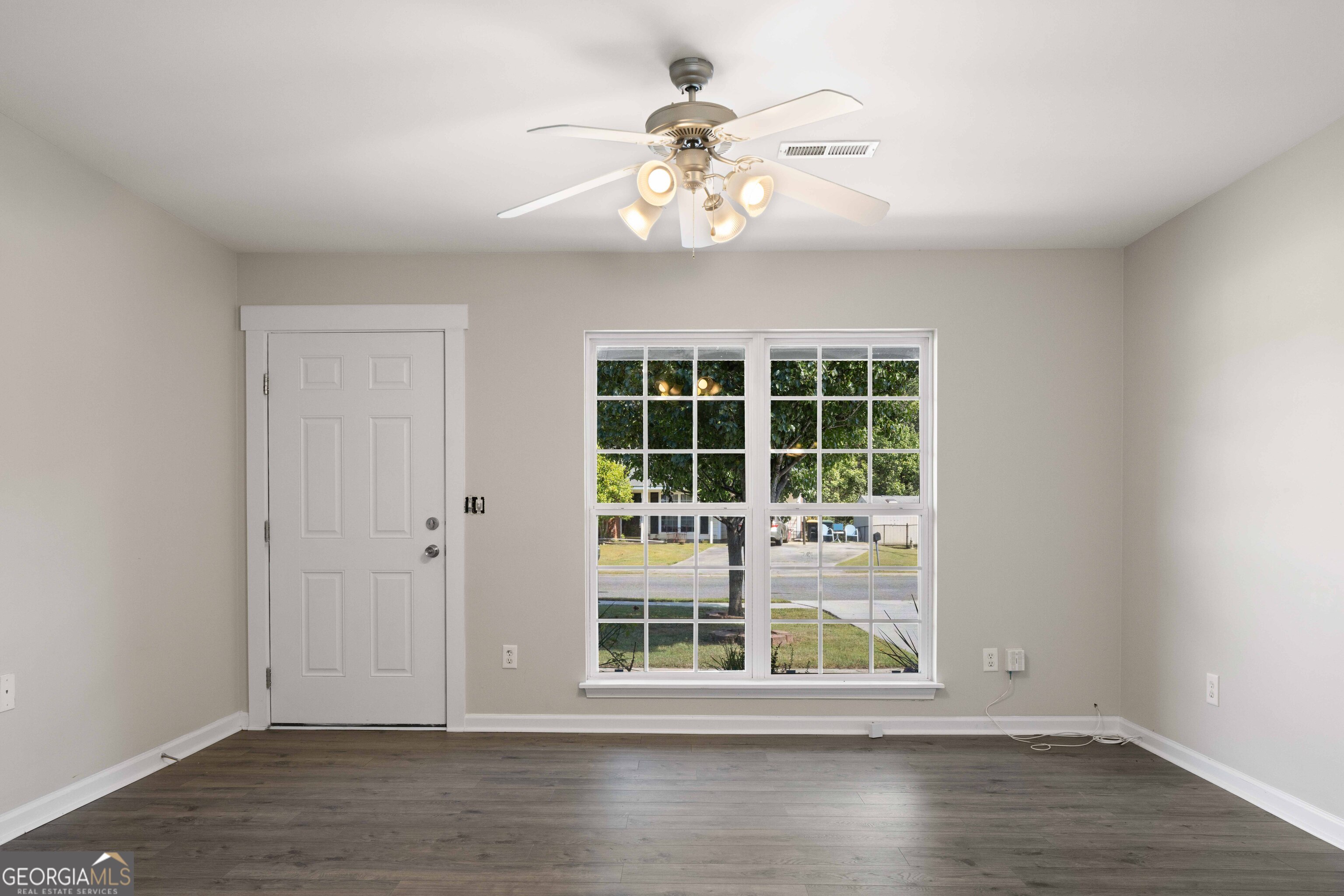 33 Northwest Hunters Glenn Road Rome, GA 30165 - Photo 24 of 43 a view of an empty room with wooden floor and a window