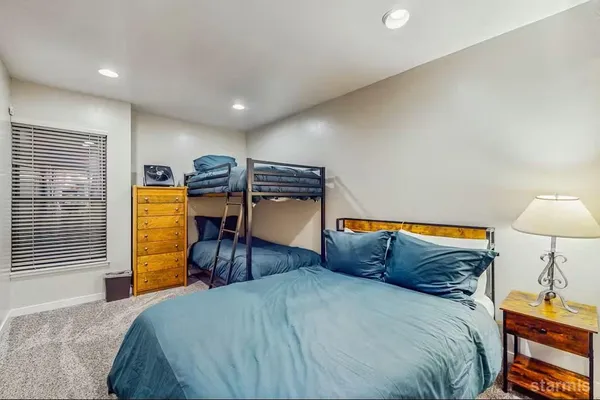 a bedroom with a bed and dresser