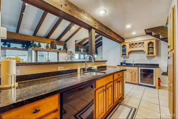 a kitchen with stainless steel appliances granite countertop sink stove and cabinets