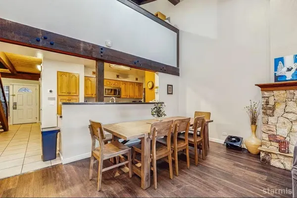 a dining room with furniture and wooden floor