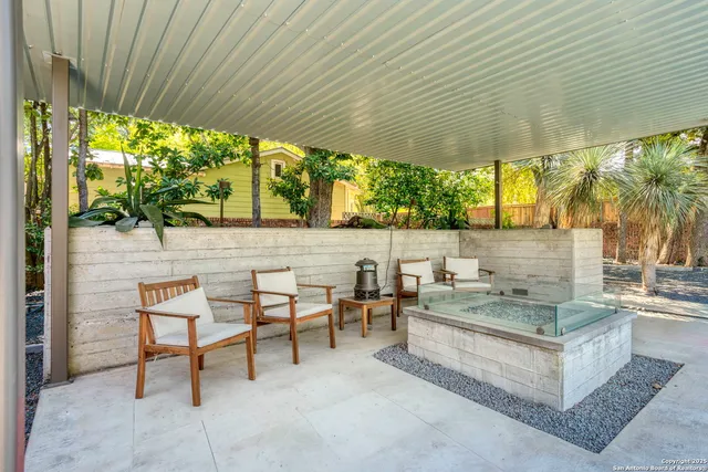 a outdoor space with the couches and dining table and chair with the garden view