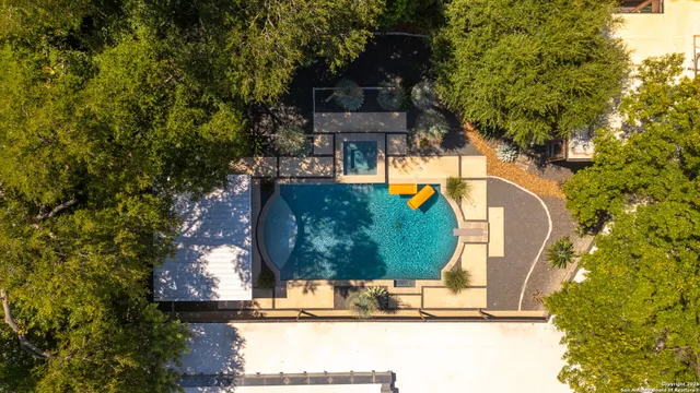an aerial view of a house with a yard and fountain