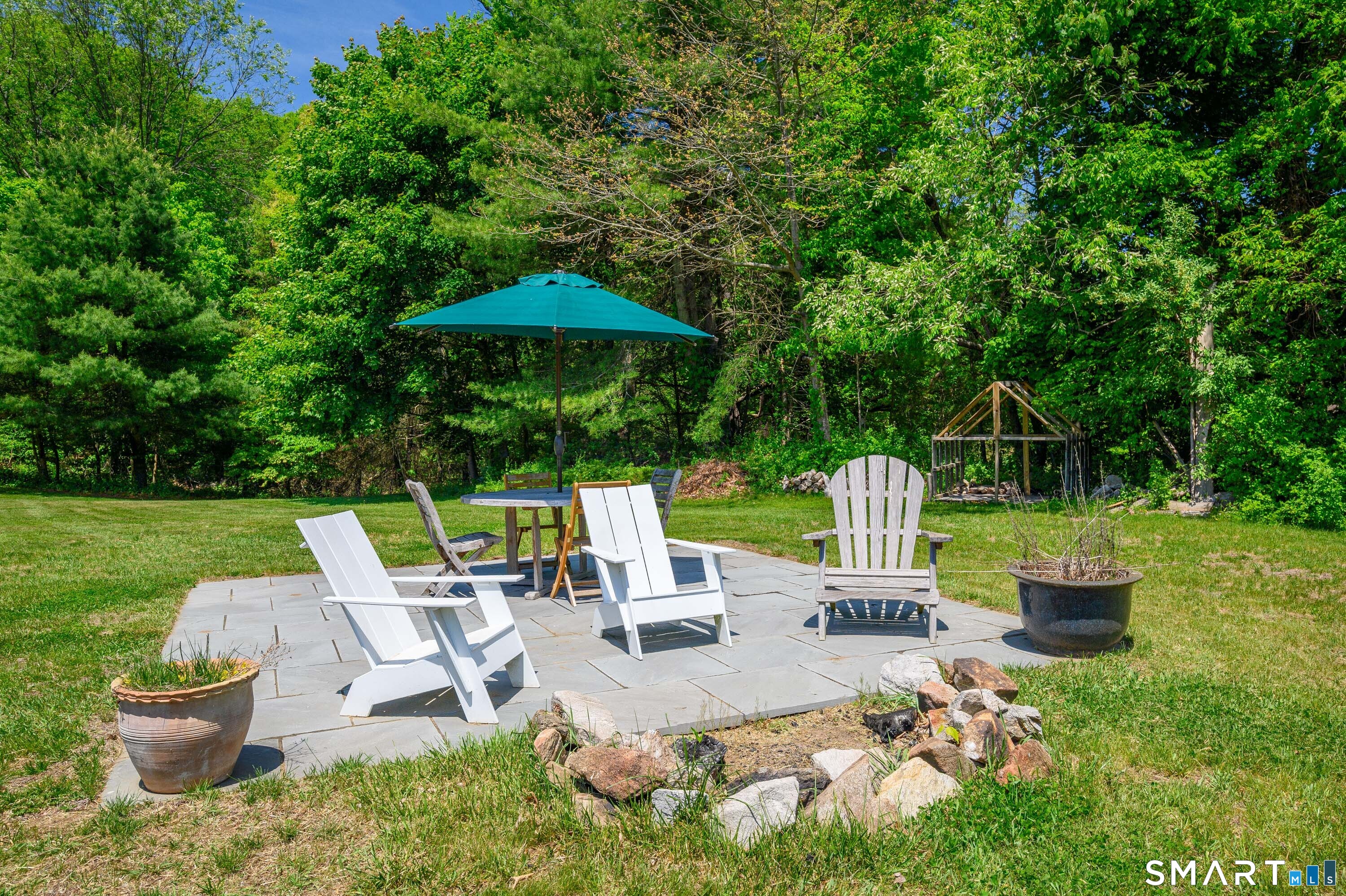 174 Huntingtown Road Newtown, CT 06470 - Photo 39 of 40 a view of backyard of house with seating space