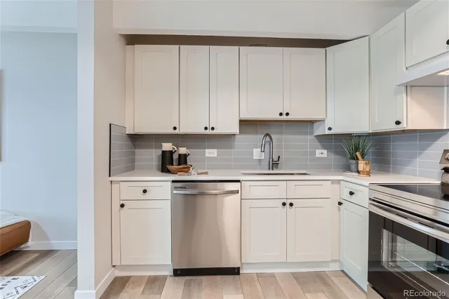 a kitchen with white cabinets and white appliances