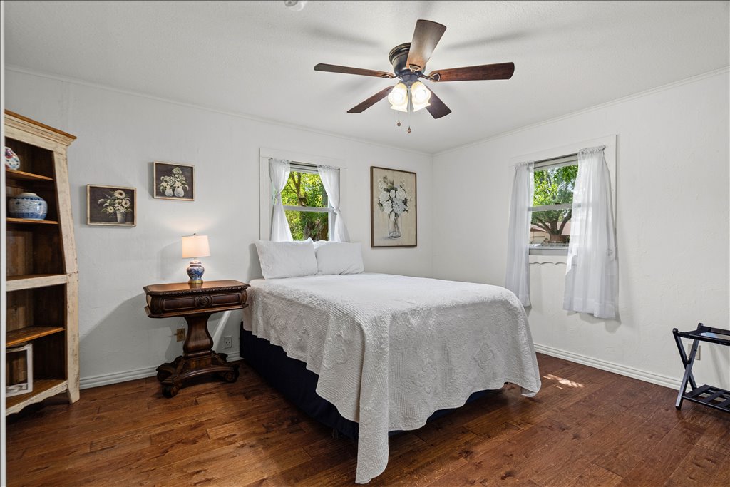 2421 Post Oak Road Webberville, TX 78653 - Photo 21 of 36 The third bedroom has a really crisp, clean feel with the bright white walls and that rich wood flooring continuing through.