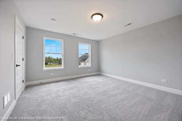 a bathroom with a double vanity sink a mirror and a bathtub