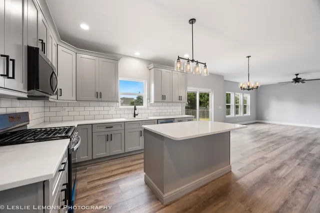 a view of empty room with wooden floor and windows