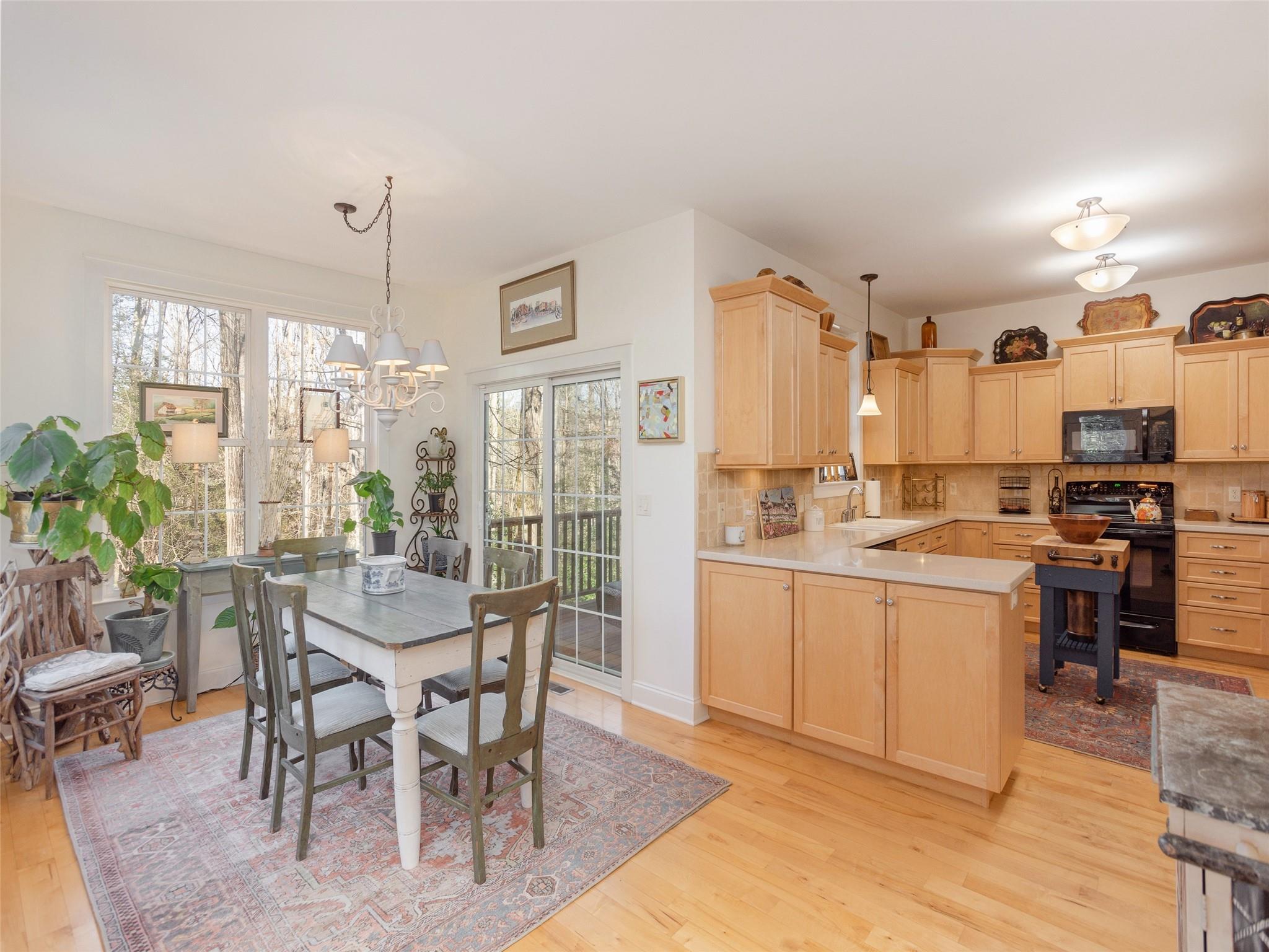 73 Cave Lane Arden, NC 28704 - Photo 17 of 45 a kitchen with a table chairs sink and cabinets