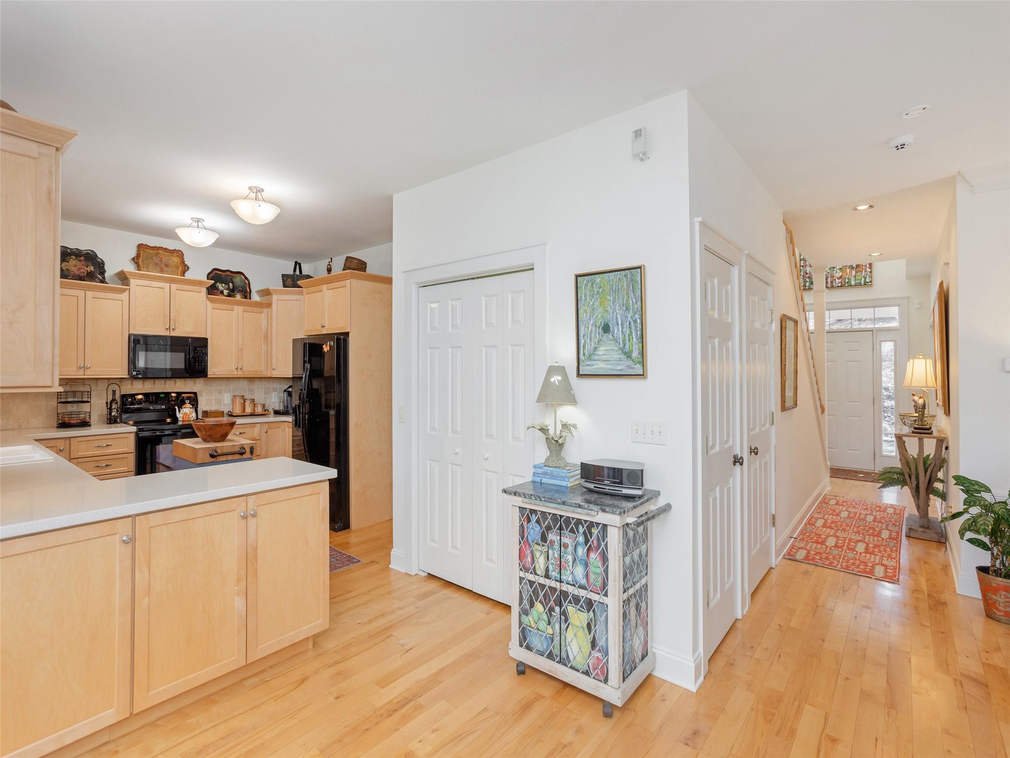 73 Cave Lane Arden, NC 28704 - Photo 18 of 45 a open kitchen with sink a refrigerator and wooden floor