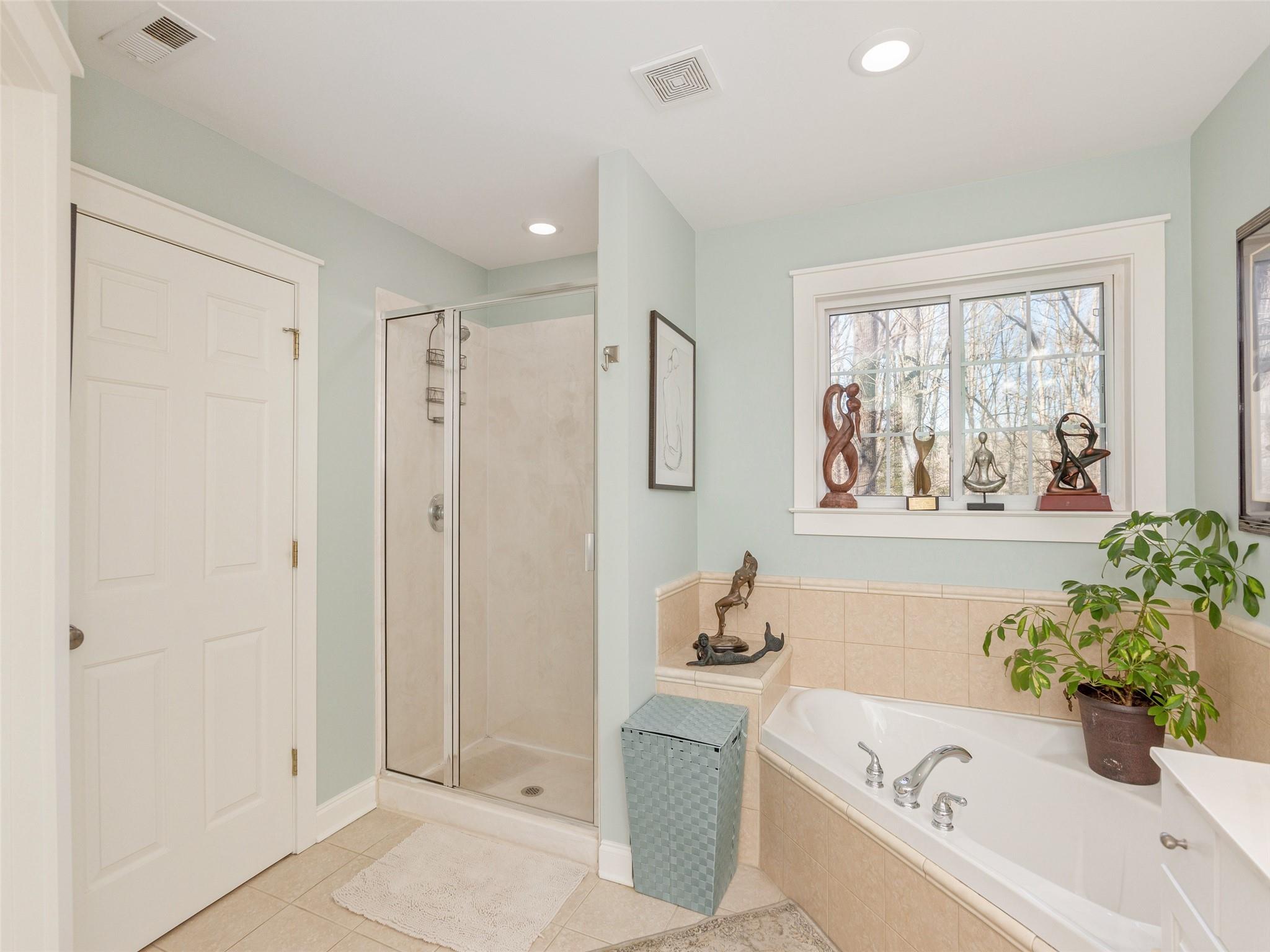 73 Cave Lane Arden, NC 28704 - Photo 29 of 45 a bathroom with a tub a sink and a window