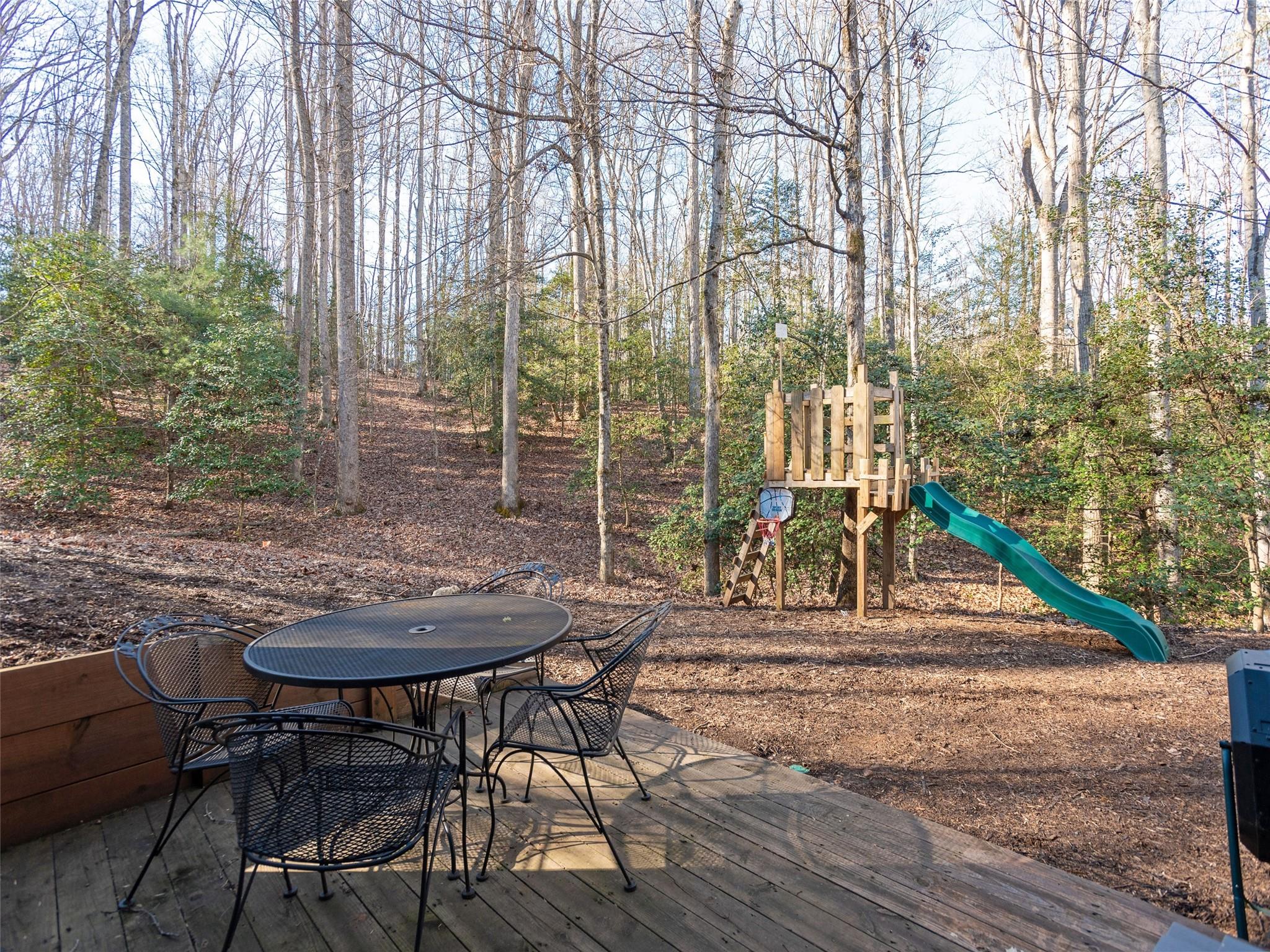 73 Cave Lane Arden, NC 28704 - Photo 42 of 45 a view of a patio with table and chairs and potted plants