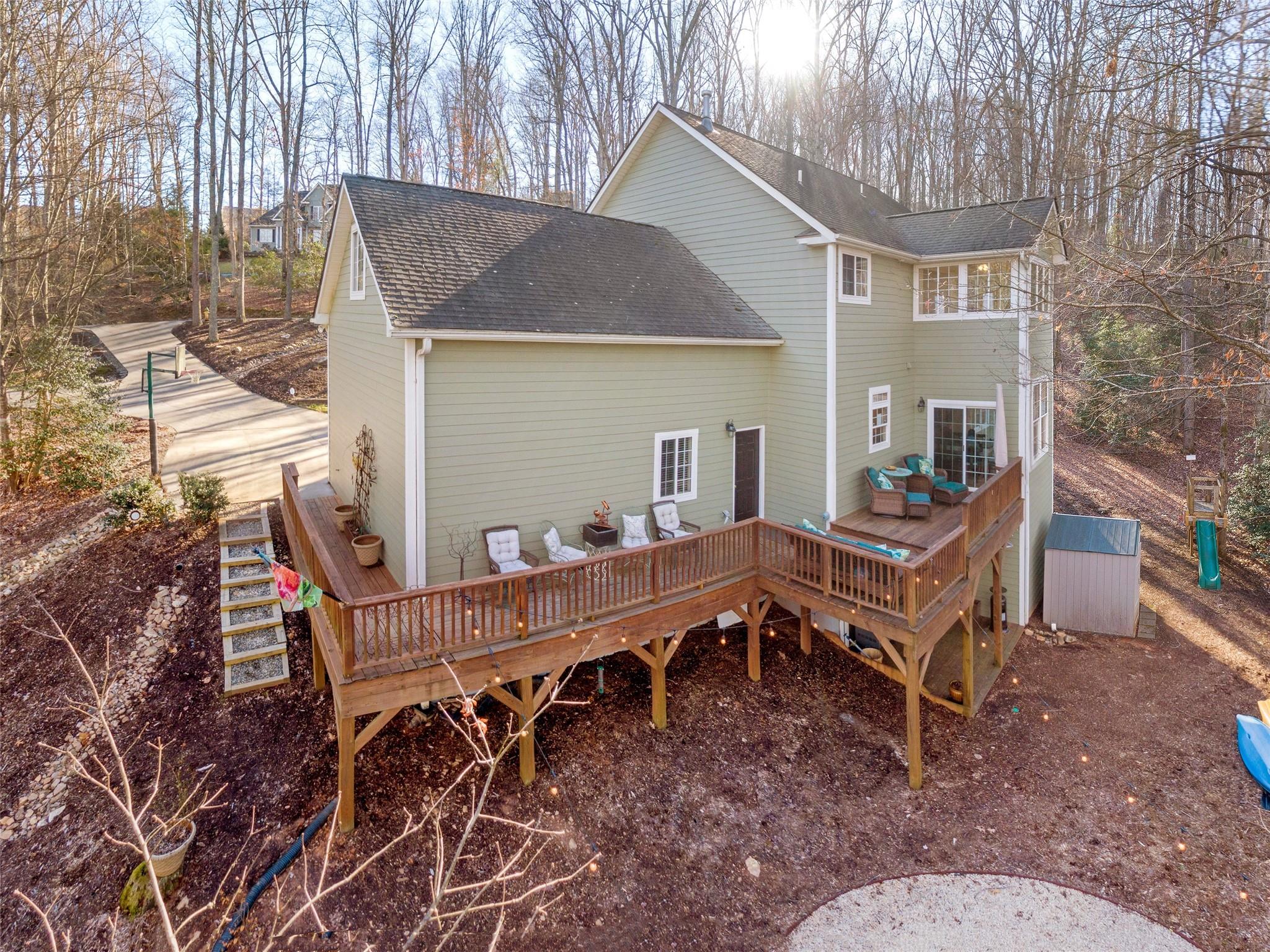 73 Cave Lane Arden, NC 28704 - Photo 44 of 45 a view of a house with a wooden deck and furniture