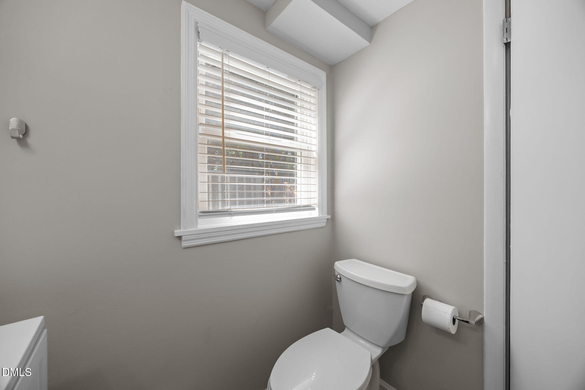 3523 Brentwood Road Raleigh, NC 27604 - Photo 19 of 43 a white toilet sitting next to a window in a bathroom