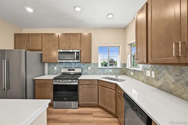 a kitchen with a sink a stove and refrigerator