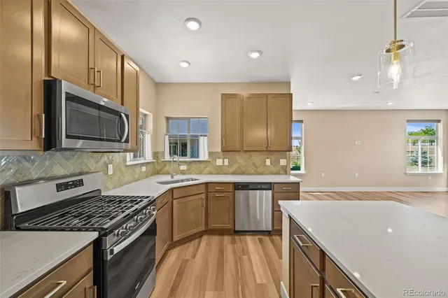 a kitchen with a sink stove and microwave