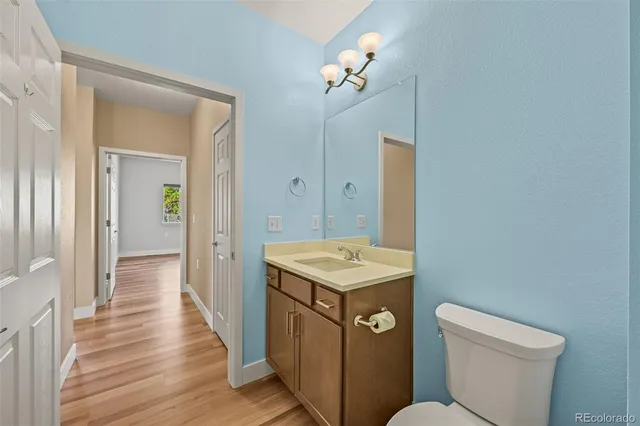 a bathroom with a sink a toilet a mirror and vanity