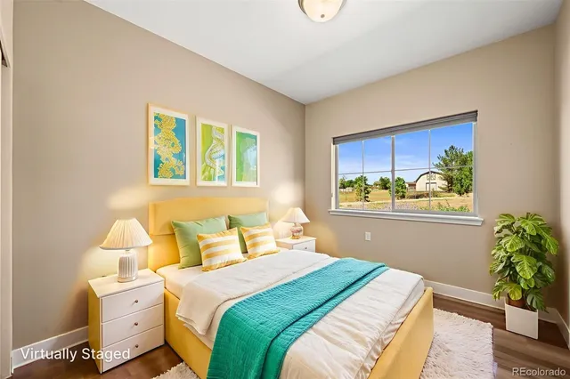 a bedroom with a bed and a potted plant
