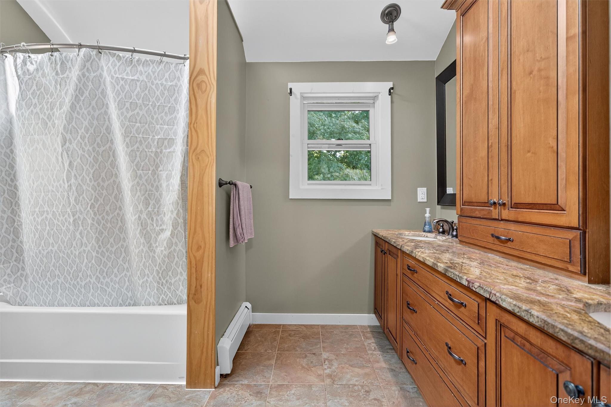 321 Bellvale Lakes Road Warwick, NY 10990 - Photo 24 of 33 a bathroom with a granite countertop sink and a bathtub