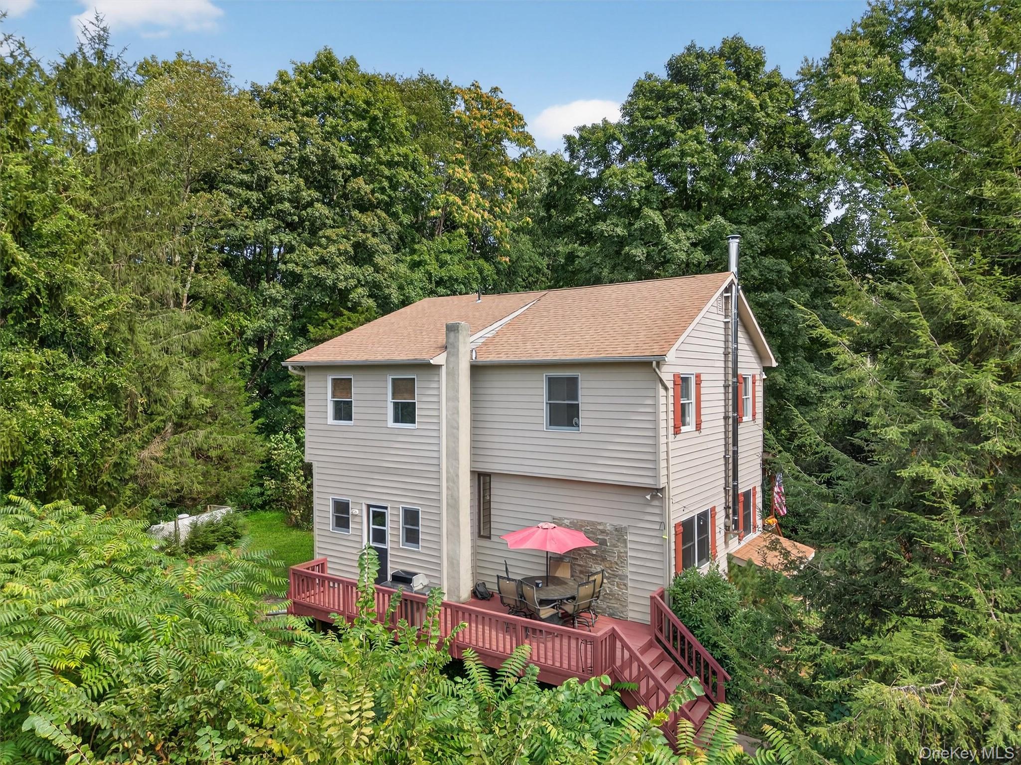 321 Bellvale Lakes Road Warwick, NY 10990 - Photo 29 of 33 a aerial view of a house with table and chairs in a yard