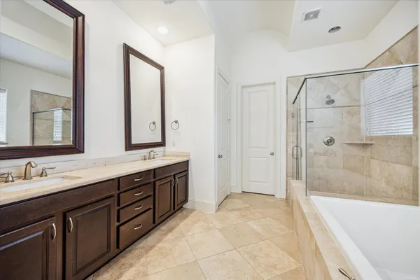 a spacious bathroom with a double vanity sink mirror double and bathtub
