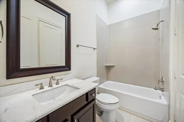 a bathroom with a sink a toilet a mirror and shower