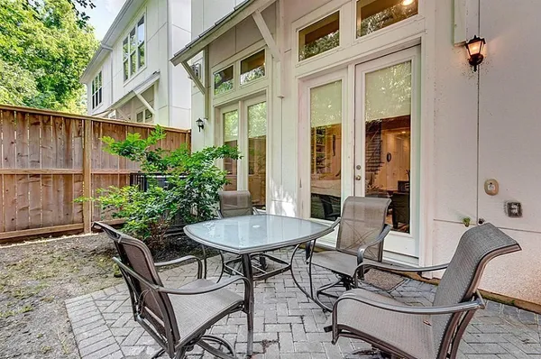 a view of a patio with a table and chairs in patio