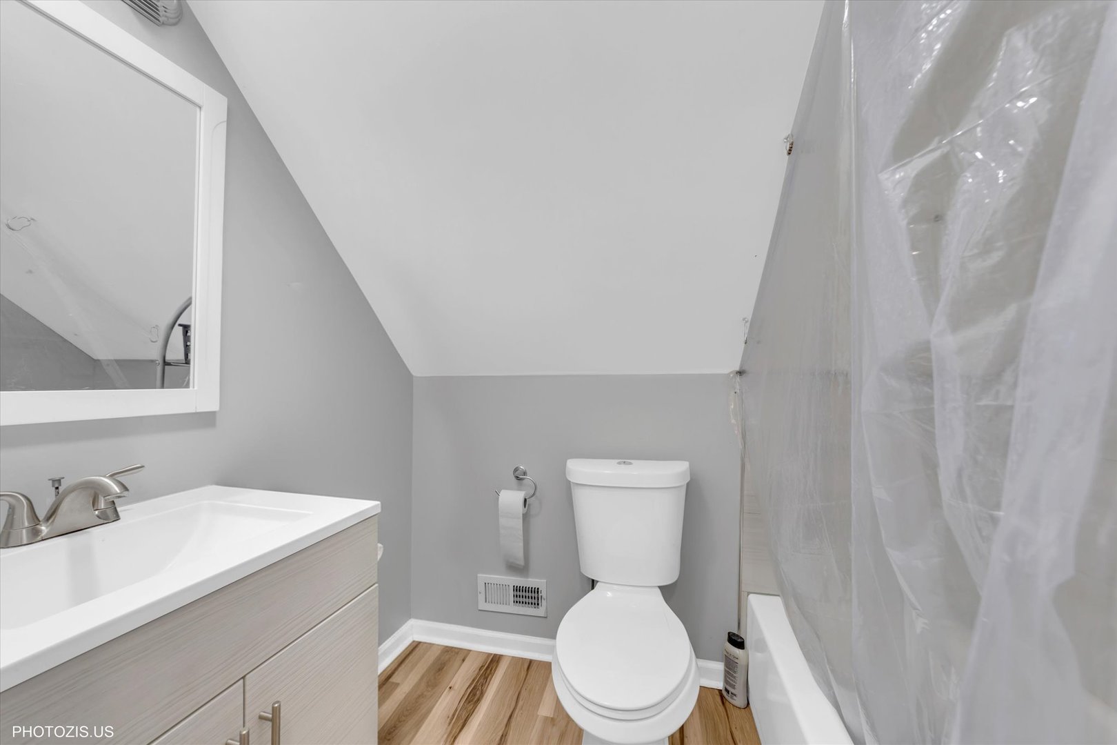 8404 South Exchange Avenue Chicago, IL 60617 - Photo 20 of 48 a white toilet sitting next to a bathroom sink