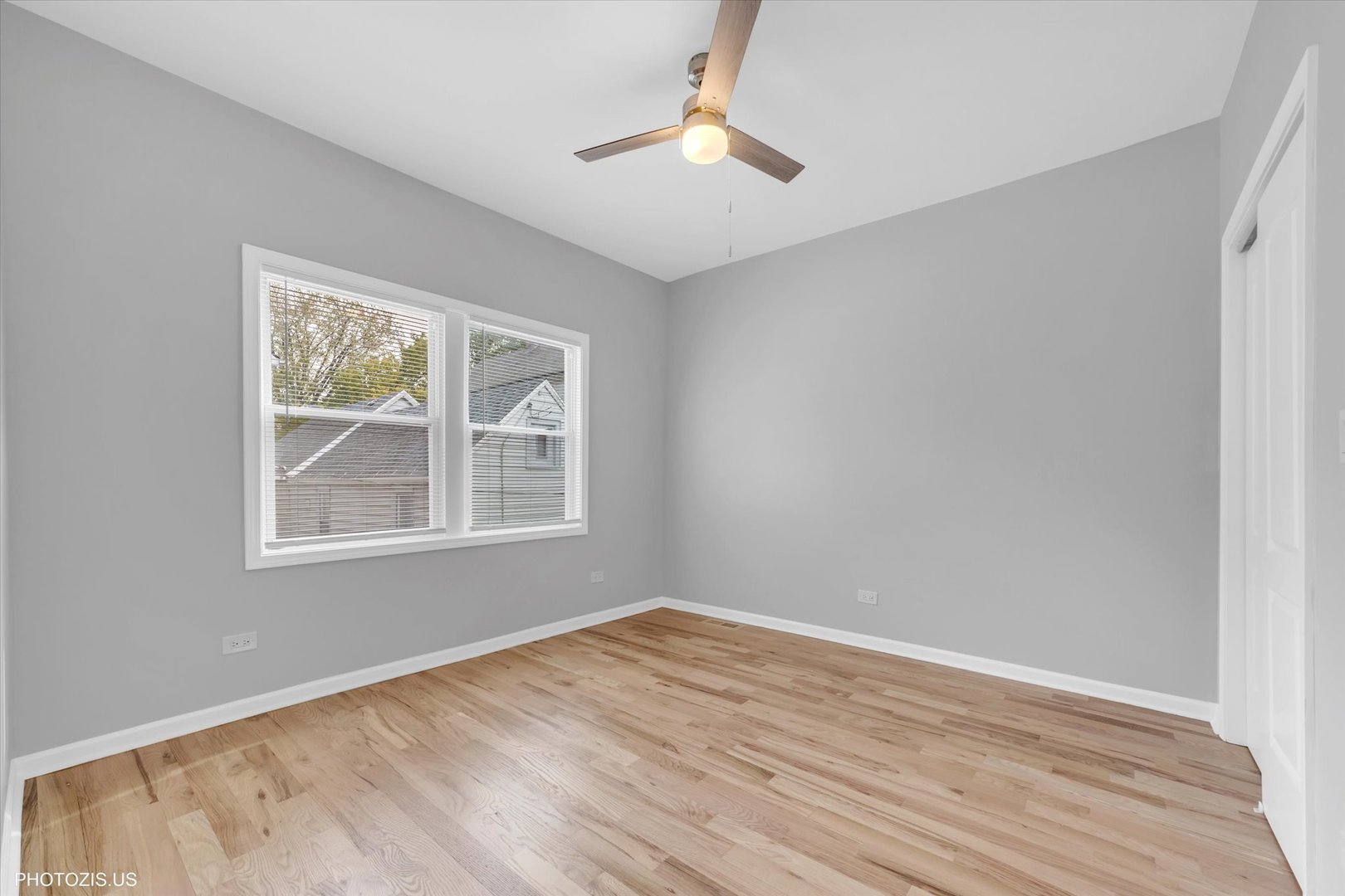 8404 South Exchange Avenue Chicago, IL 60617 - Photo 32 of 48 a view of an empty room with wooden floor and a window