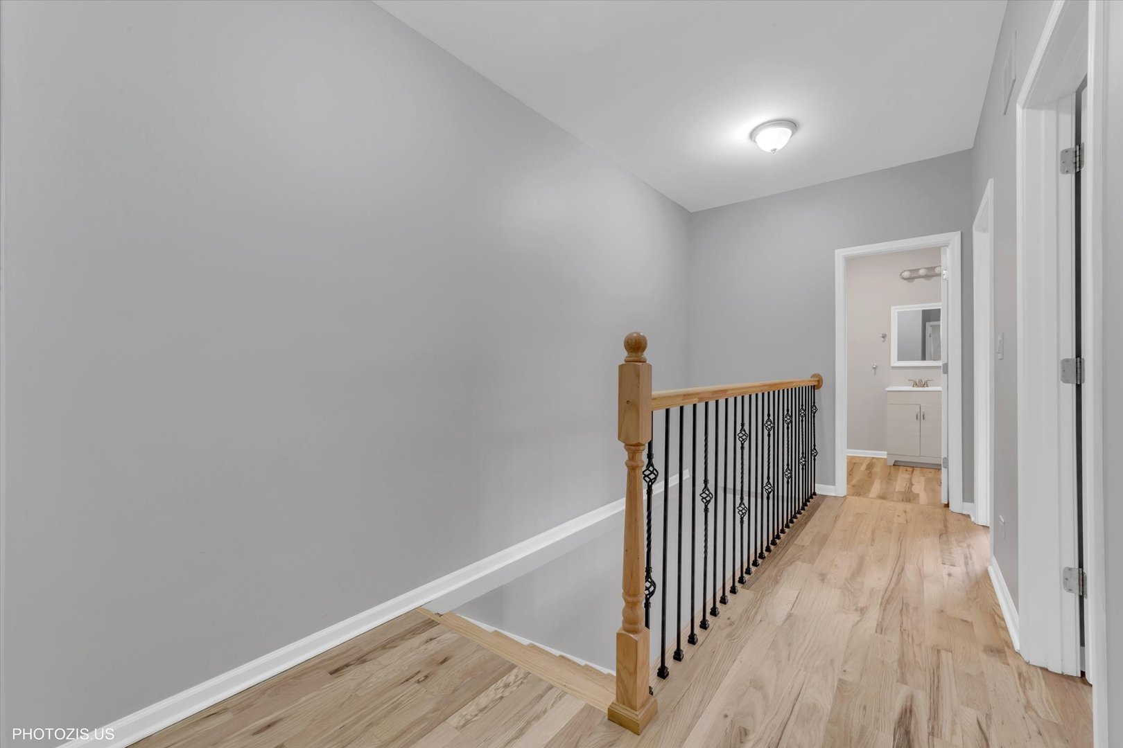 8404 South Exchange Avenue Chicago, IL 60617 - Photo 37 of 48 a view of a hallway with wooden floor and staircase