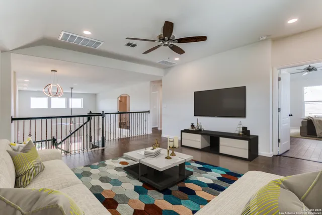 a living room with furniture and a flat screen tv
